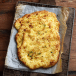 Baked cottage cheese flatbread recipe on parchment paper